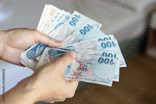 Man holds a pack of Turkish lira. Cash withdrawal in Turkey