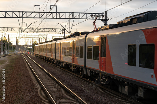 Express train moves from empty station at sunset light. Technology allows people to travel and plan journey. High-speed train starts journey reaching new destination to pick up and drop off passengers