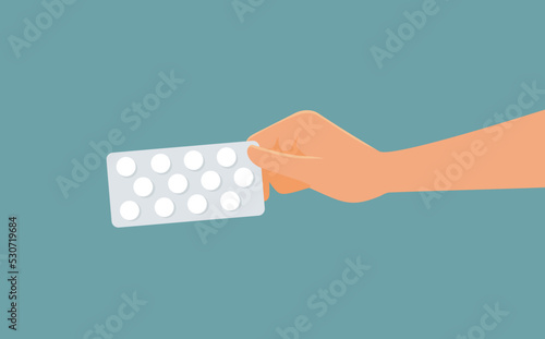Hand Holding a Pack of Pills Vector Cartoon Illustration. Patient holding a blister pack of medication for curing illness 