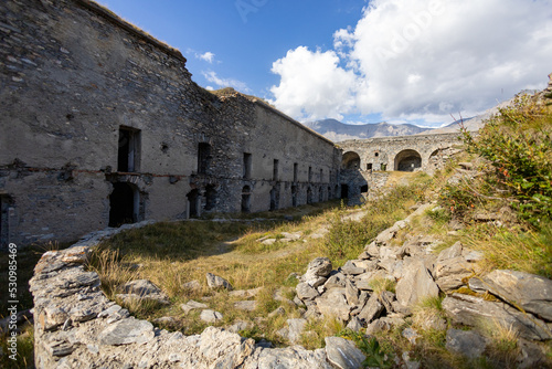 View of Fort Variselle at Lake Montcenis (Moncenisio) on the border between Italy and France. Old ancient historical fort ruins in stone in the Alps mountains