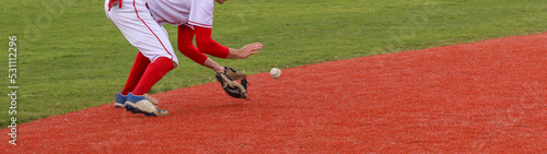 Baseball infielder fielding a ball during a game