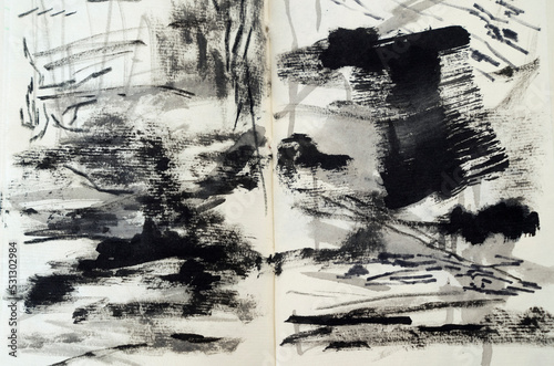 Abstract and expressive art. Closeup view of a modern non figurative black and white painting drawn in a notebook.