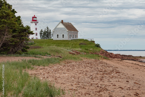 Starting operation in late 1853, Panmure Island Lighthouse is the first lighthouse on P.E.I. built of wood. Now automated, it is a heritage site. The gray house is the fog alarm building.
