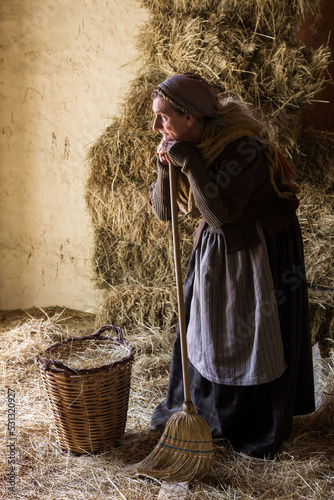 Standing peasant woman with broom