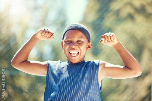 Children, sports and fitness with a strong boy flexing his biceps and having fun with sport outside. Kids, training and workout with a young male child outdoor for exercise, recreation or development