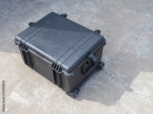 Black case on wheels. Shockproof case for expensive equipment. Concept case for multimedia or sound equipment. Boxing on wheels top view. Protective corps for transporting equipment.