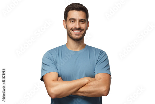 Indoor portrait of young european man standing in blue t-shirt with crossed arms, smiling and looking at camera