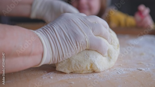 Adult Caucasian Woman Kneading the Dough on Breadboard