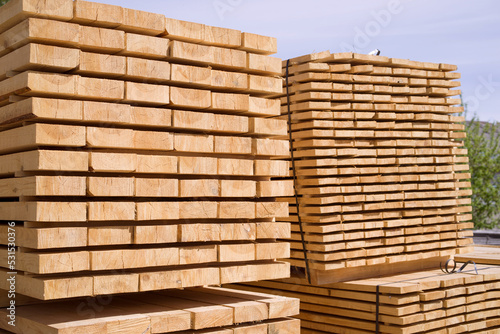 Stack of fresh pine boards in a sawmill warehouse. Harvesting, sale of lumber for construction 