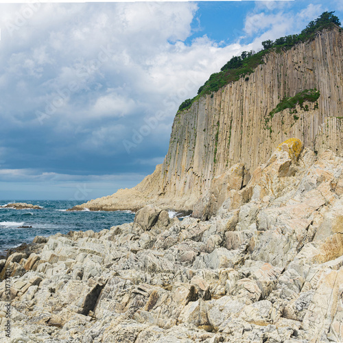 coast of Kunashir Island on Cape Stolbchaty with basalt columned rocks