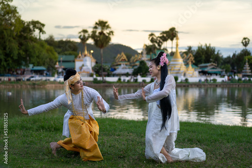 Man and woman in Burmese traditional Dancing perform the cultural costume of Tai people minority ethnic show wearing dresses Shan State style.