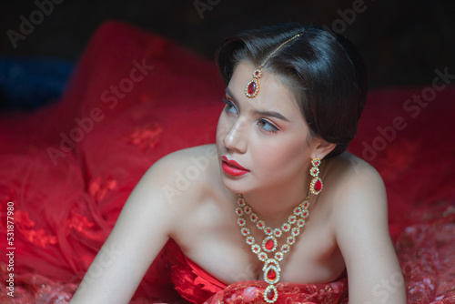 Beautiful portrait fashion of a young Asian woman in traditional Hindu Red Saree wedding clothes with bride dress makeup and jewelry gorgeous red bridal.