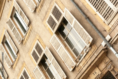 Shot of old wooden windows on a building in Nancy, France.