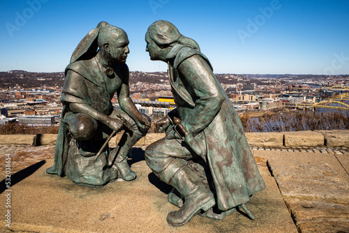 The bronze statue of George Washington and Seneca leader Guyasuta, in Pittsburgh, PA. Heinz field behind.