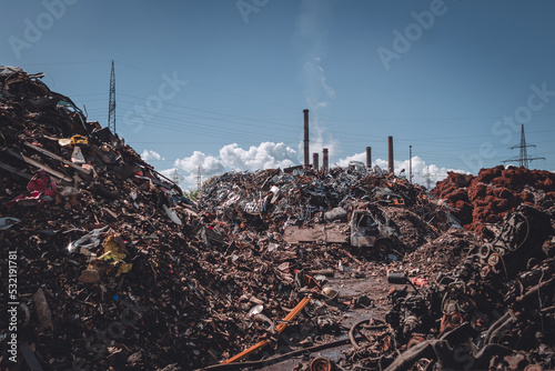 junkyard with factory in background