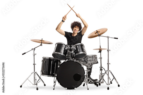 Young male drummer holding drumsticks up