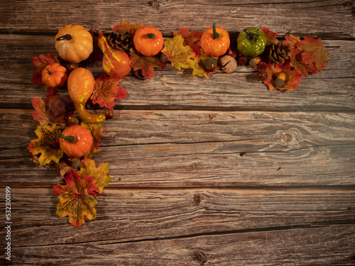 Autumn composition. Pumpkins, dried leaves on wooden background, fall halloween concept