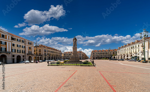 Cuneo, Piedmont, Italy - August 06, 2022: View on Tancredi Duccio Galimberti Square with Statue of Giuseppe Barbaroux, in the background the beginning of corso Nizza