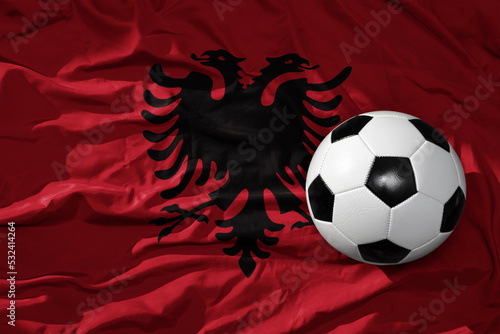 vintage football ball on the waveing national flag of albania background. 3D illustration