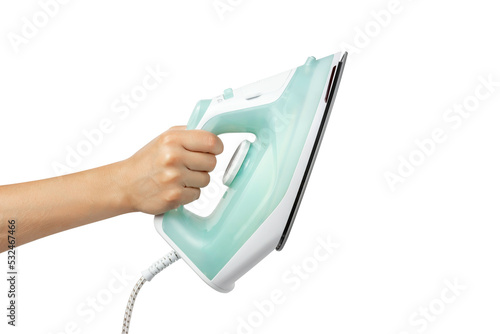 Electric iron in hand isolated on white background. A woman's hand holds an iron. Clothes iron in hand.