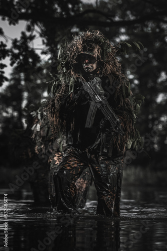 Eastern special forces soldier with rifle in the jungle