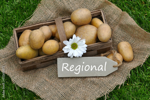 A basket of potatoes with the text regional on a sign.