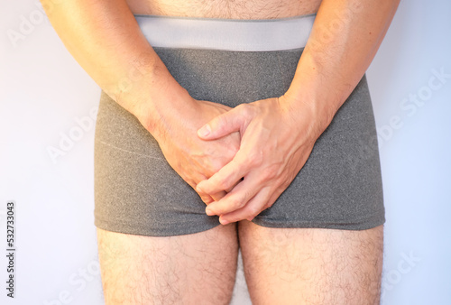 Man suffering from benign prostatic hyperplasia, a urinary tract infection, and polycystic ovary syndrome. Pain and suffering in his genitals are used in the concept of health care.