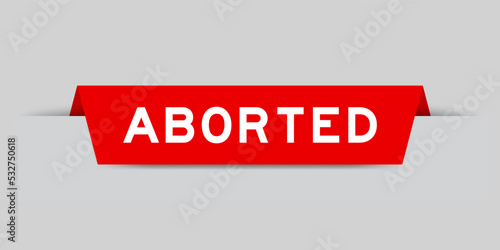 Red color inserted label with word aborted on gray background