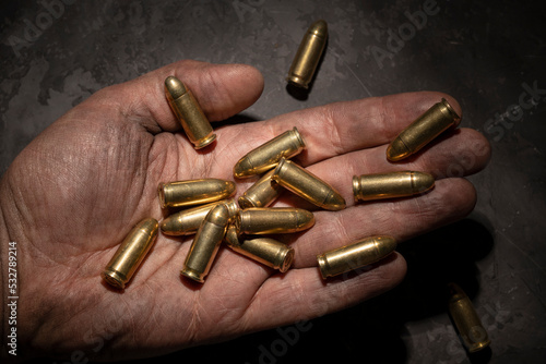 9mm pistol cartridges in the palm of a man.
