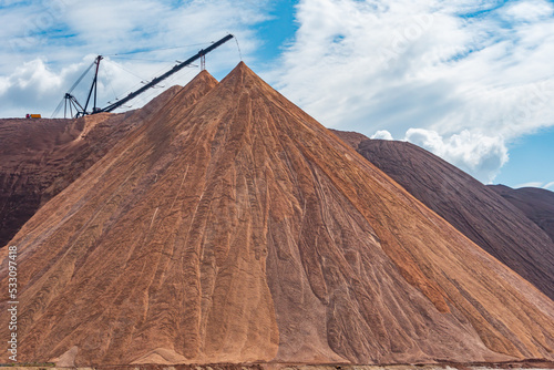 Mining industry close up. Telestacker handles the ore closeup for potash waste heaps, extraction of salt and potash fertilizers in a quarry and processing of ore