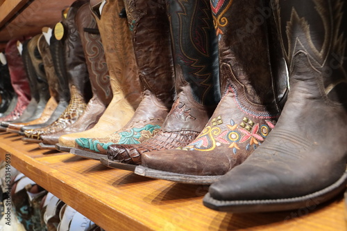 A long row of cowboy boots on sale at a store in Texas
