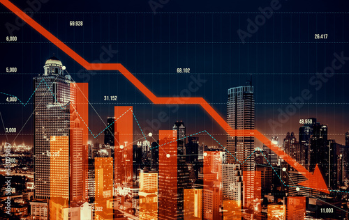 Economic crisis concept shown by declining graphs and digital indicators overlap modernistic city background. Double exposure.