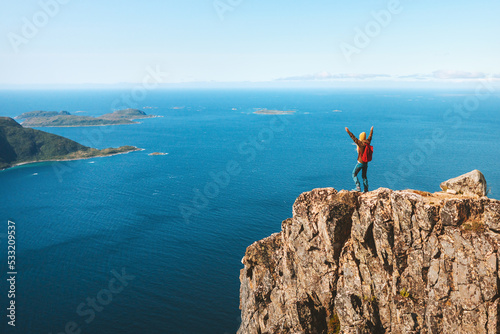 Hiker woman on mountain cliff edge over sea travel in Norway healthy lifestyle success motivation concept adventure active vacations hiking outdoor