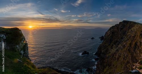 sunset over the Atlantic Ocean and the cliffs of Bray Head on Valentia Island in County Kerry