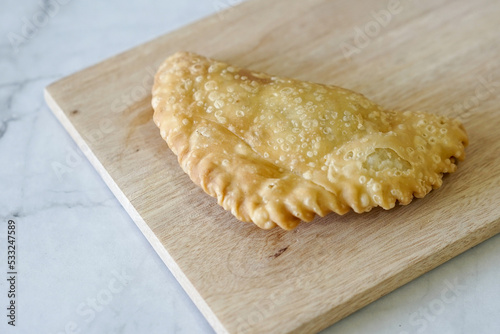 Cornish pasty filled with chicken and potato. Pastry minced pie or Pastel asian style cuisine. Homemade flaky pasty with mince meat filling 