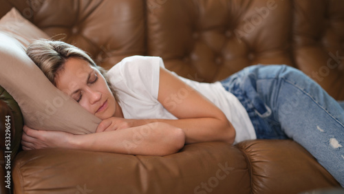 Woman sleeps in living room taking break for short nap in middle of day