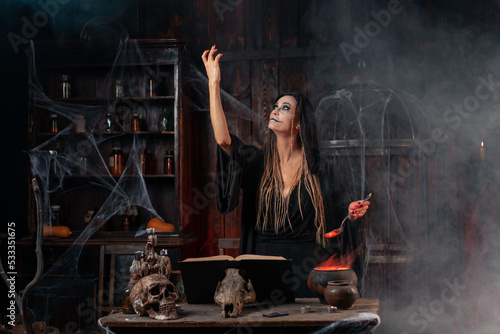 Halloween, witch use magic book and cauldron prepare poison or love potion