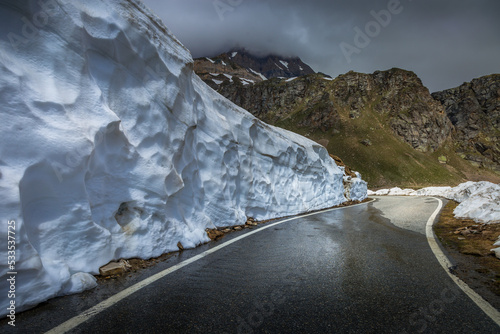 Alpine mountain road between snow at springtime, Gran Paradiso Alps, Italy