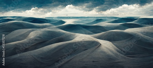 Endless desolate desert dunes, far horizon with spectacular clouds. Waves of surreal sand fabric folds landscape. Minimalist lost and overwhelming lonely feeling - moody subdued blue color tones.