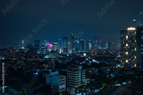 Night city view of business district with skyscrapers in Manila, Philippines