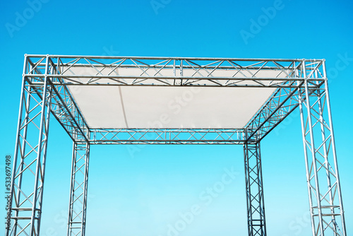 Metal structure with a woven canopy for mass events. A fragment of a mobile concert stage made of aluminum pipes. Close-up