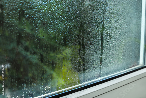 Window glass with water drops, closeup. Condensation