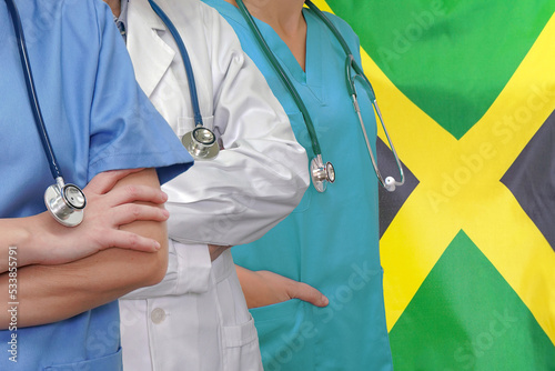 Three Doctors with stethoscope in standing on Jamaica flag background. Close-up medical team. Group of doctors and nurses. Innovative technologies in medical development in Jamaica