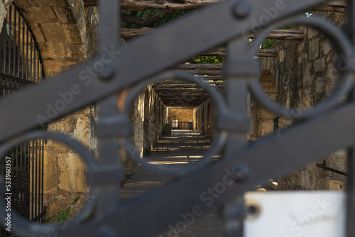 The Alamo side barracks looking through an iron gate