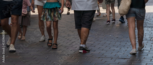 feet of people walking on a street