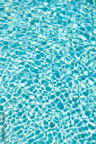 turquoise color background of swimming pool water with ripples. concept of summertime