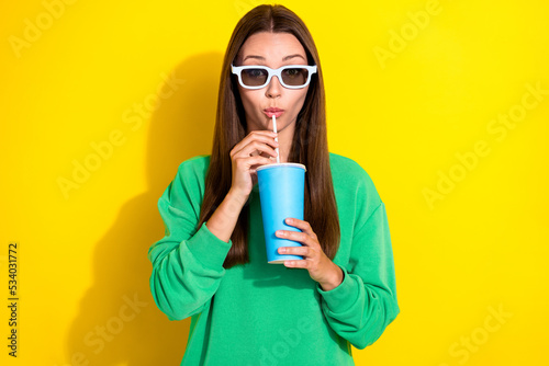 Portrait of nice young lady hands hold sipping drink cup straw isolated on yellow color background