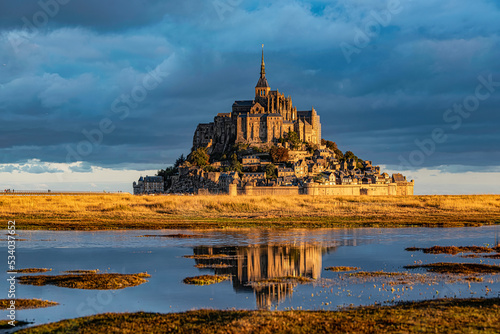 Breathtaking sunrise at the famous Le Mont Saint-Michel tidal island , Normandy, France