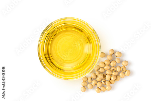Glass bowl of soybean oil with soybeans isolated on white background. Top view 