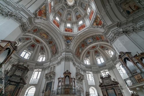 Inside undershoot of a dome of Salzburg Cathedral with paintings and golden frames